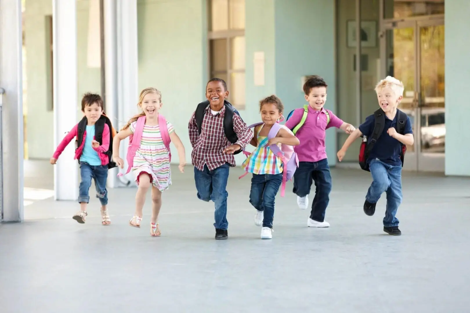 A group of children running in the school yard